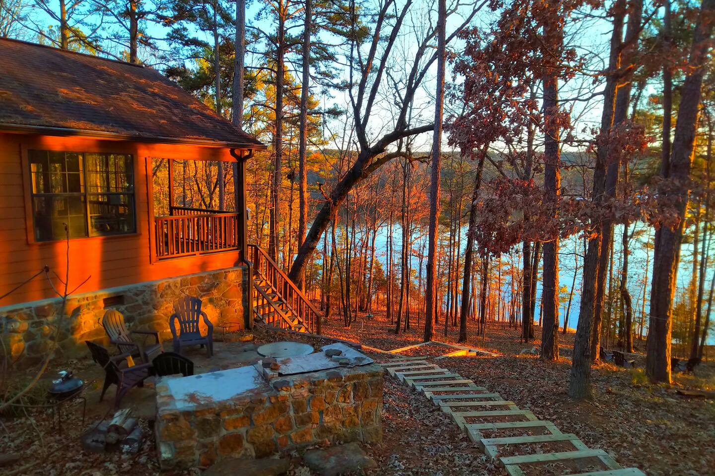 Breathtaking sunset views over Greers Ferry Lake, perfect for ending your day in tranquility
Outdoor seating area with a fire pit and BBQ grill, ideal for cozy evenings and marshmallow roasting under the stars

