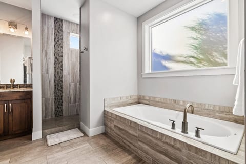 En-suite master bathroom with soaker tub and walk-in shower