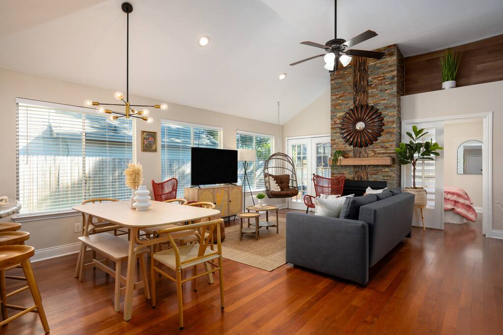 Comfort meets style: living room with dining, natural light, TV, and charming accents