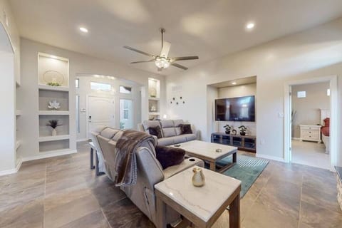 Converge in this bright and spacious living room that offers a cozy sectional sofa, a extra large Smart TV, stylish decor, and a family-friendly layout, perfect for relaxing together after a day of adventure.