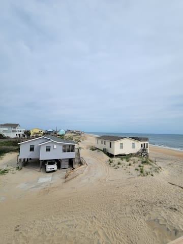 View of the cottage. Second house back from the beach. The cottage is blue in color. 