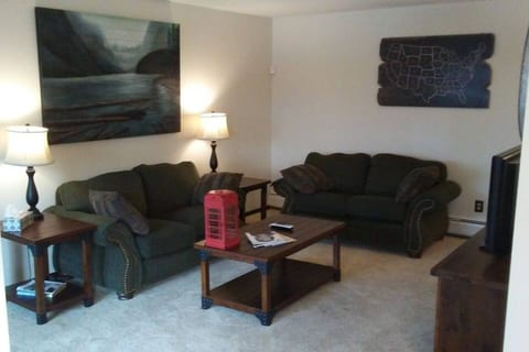 Living Room w/love seats, patio access, and Roku TV