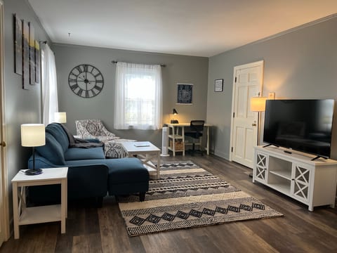 Living Room w/sectional sleeper, desk, two closets, chair and Roku TV