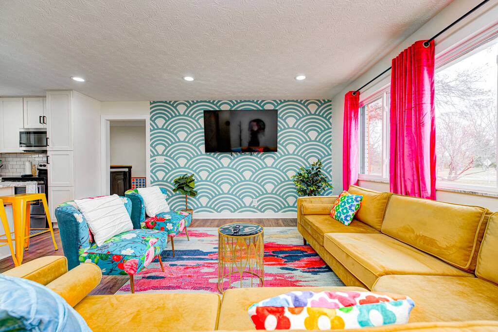 Picturesque living room with a large sectional sofa, accent chair right in front of a 65 inch TV. Perfect for movie night, playing games and gathering as a group :)