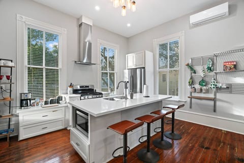 Our modern kitchen has seating with the kitchen island as well as around the corner. The kitchen is fully stocked with all the supplies you need to cook a great meal together! We also provide coffee with all the fixings!