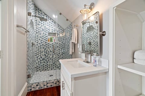 A beautifully designed shower with a large showerhead!