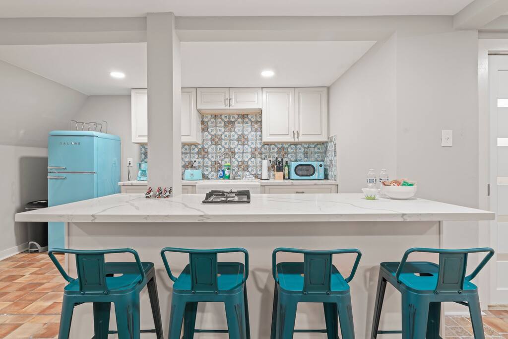 The kitchen island seats four, with space to do some work on your laptop while cooking some food or eating a meal! 