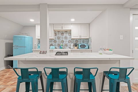The kitchen island seats four, with space to do some work on your laptop while cooking some food or eating a meal!