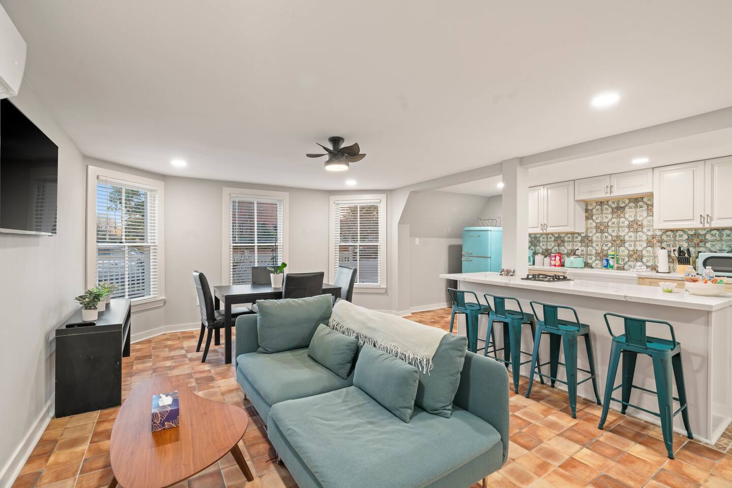 Enjoy the open-concept living area with a Smart TV and cozy couch to lounge on and watch a movie together!