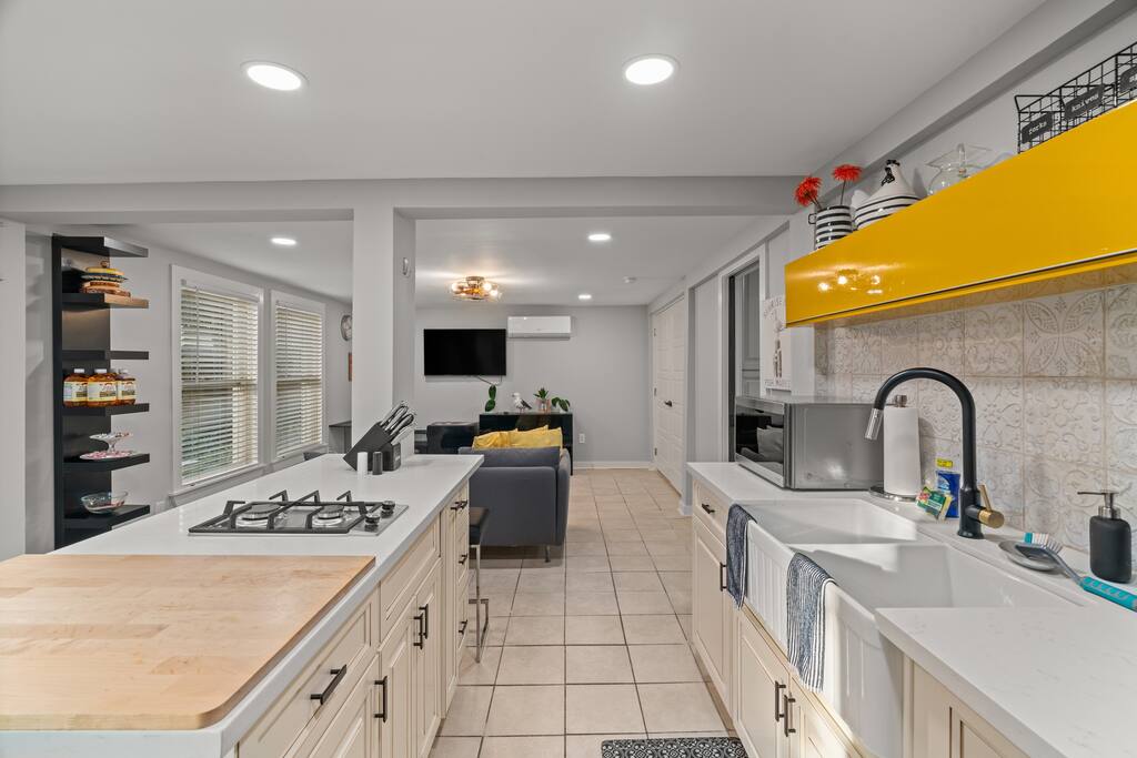 The open-concept space has plenty of space to cook a nice meal while you watch TV or you can talk together while hanging out by the kitchen island! 