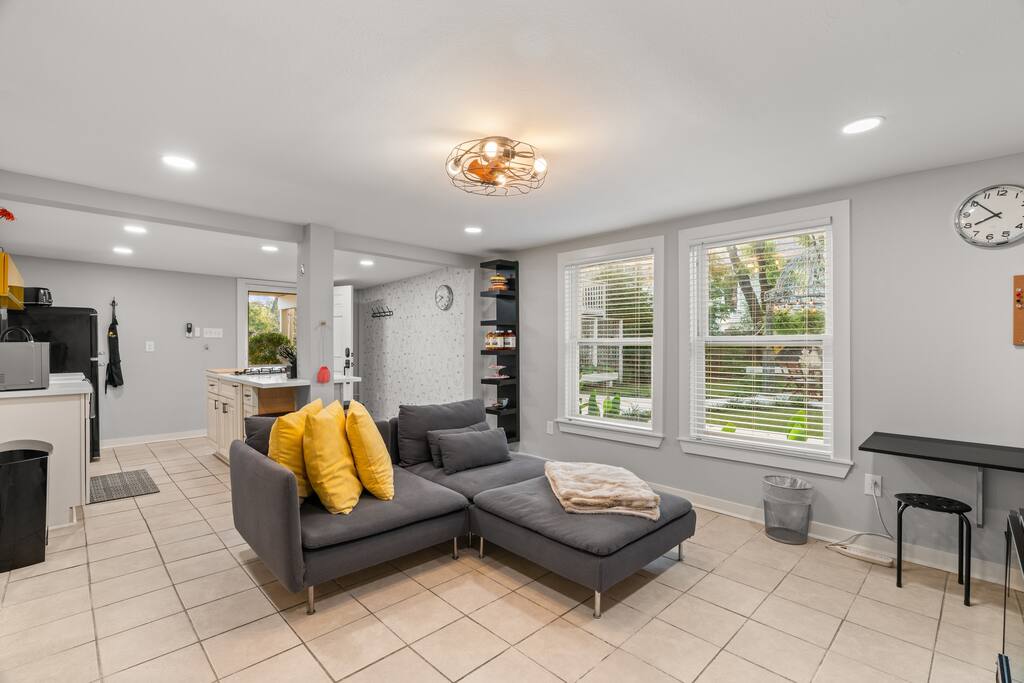 The living room includes a comfy sofa and a smart TV with all the popular streaming services. There is a dedicated workspace as well for when you need to jump on a work call! 