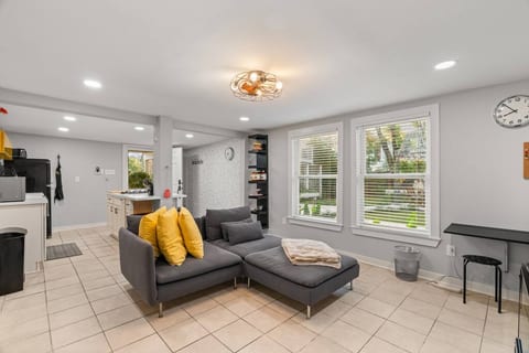 The living room includes a comfy sofa and a smart TV with all the popular streaming services. There is a dedicated workspace as well for when you need to jump on a work call!