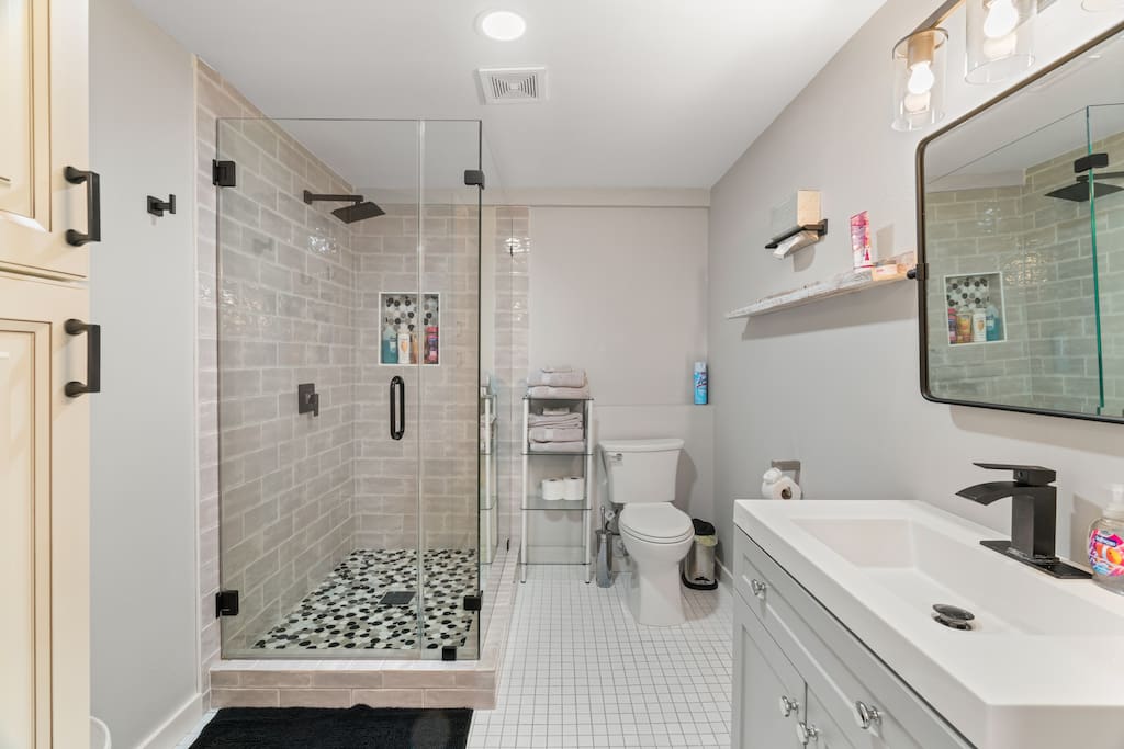 The bathroom is large with plenty of storage space and a big walk-in shower! We provide all essential amenities including hand and body soap, shampoo, conditioner, and  a few other helpful amenities! 