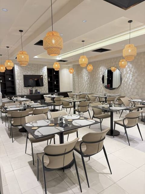 With soft golden lights and contemporary furniture, this restaurant sets the perfect mood for gatherings. The clean and chic interior makes every meal feel special.