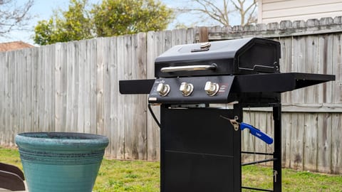 Fenced backyard with 3-burner gas grill—perfect for BBQ nights