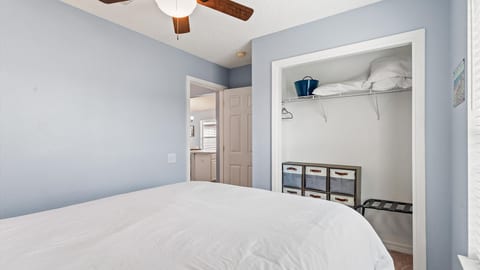 Serene bedroom with en-suite access, organized closet & ceiling fan