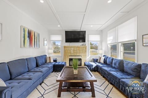 large living room with 65" smart TV and electric fireplace
