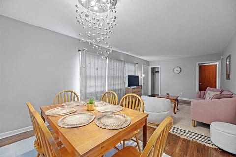 The dining area with placemats and a gorgeous lighting fixture.