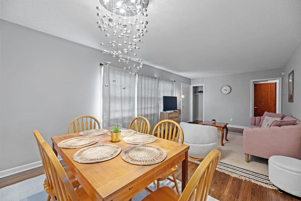 The dining area with placemats and a gorgeous lighting fixture.