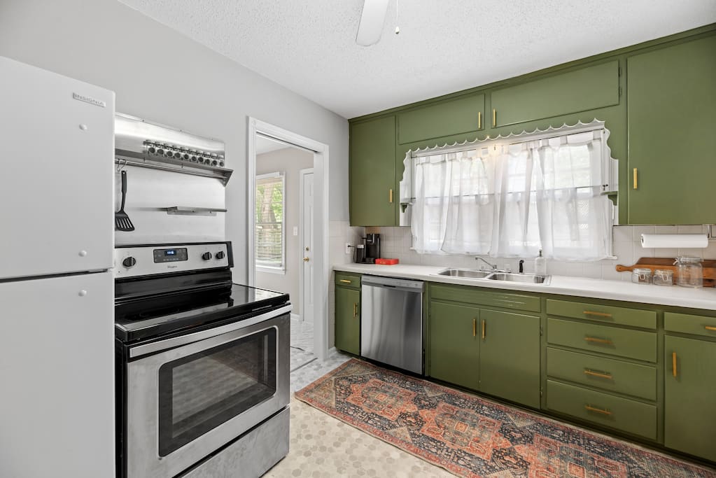 Stovetop with four electric burners, and a full sized oven. The kitchen is fully stocked for a long stay with kitchen utensils, bakeware, and flatware.