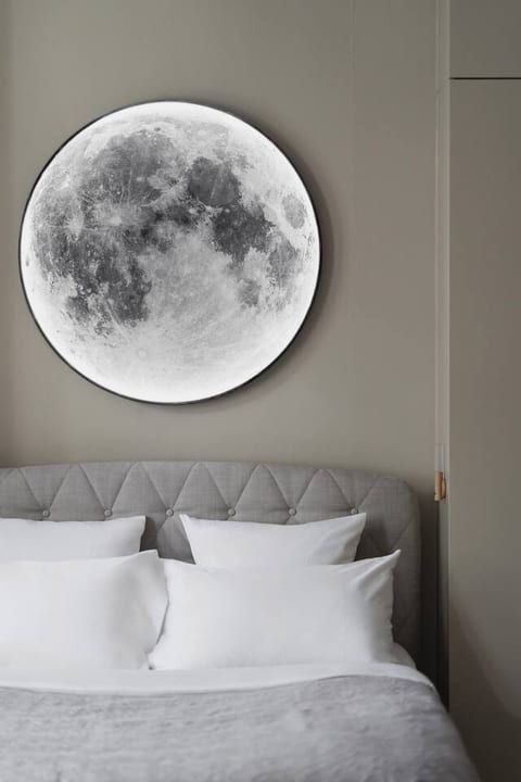 The Moon Room, one of two master bedrooms, features a striking dimmable moon lamp above the bed, creating a tranquil and celestial ambiance. This serene space invites you to unwind and enjoy a peaceful night's sleep.