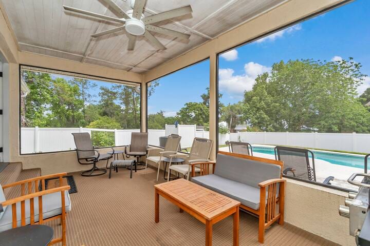 screened in Florida room with plenty of seating, ceiling fan with lights, BBQ, overlooking the year round heated pool and backyard - right off the living room. 