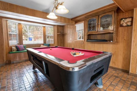 Rustic game room w/ pool table and wood-paneled walls for laid-back fun.
