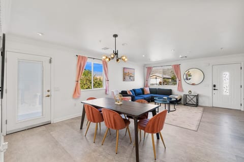 Airy dining area w/ modern table & chairs, set beside the kitchen for relaxed meals together.