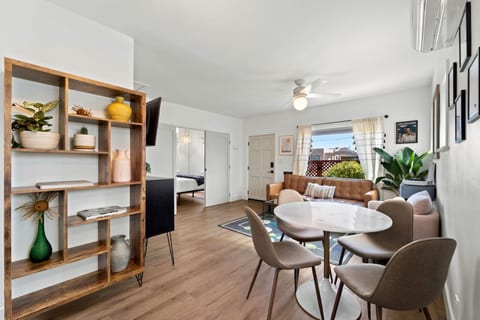 Cozy living space w/ open shelving, warm wood floors & an easy flow into the dining area.