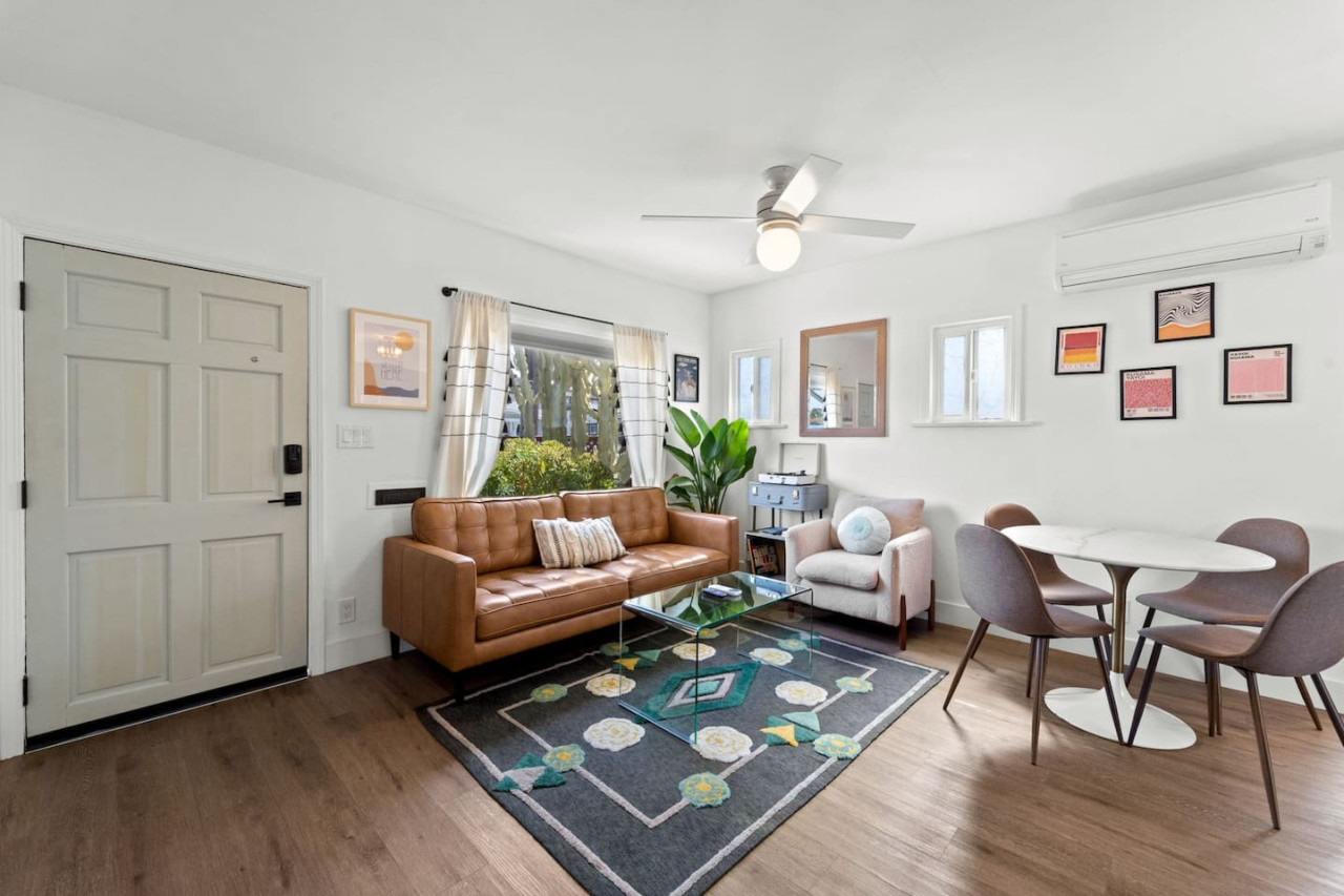 Bright open living area w/ comfy seating, playful accents & a relaxed layout perfect for unwinding after a day out.