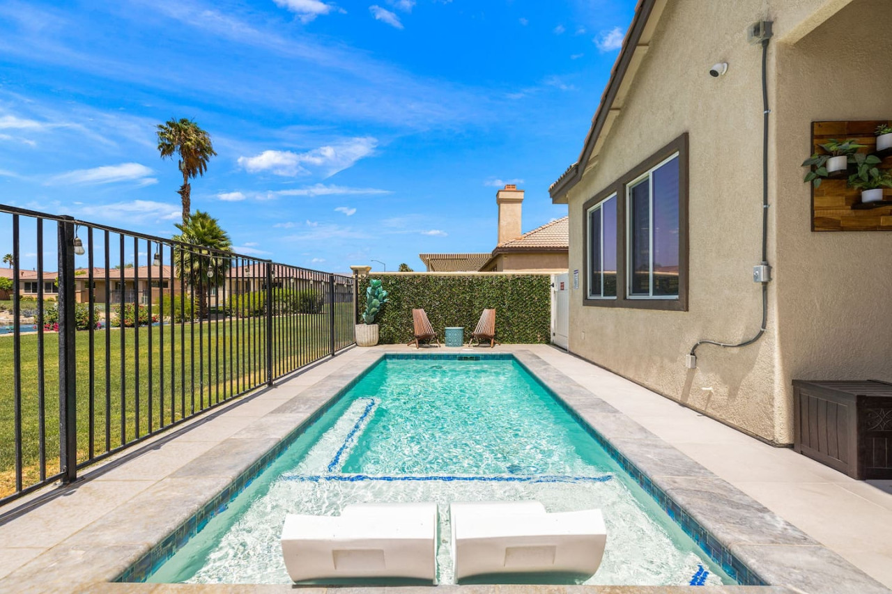 Private pool framed by a fenced patio, perfect for sunny afternoons & refreshing dips.