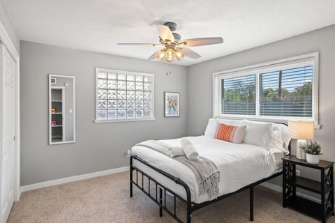 Serene bedroom w/ cozy bedding, soft tones & natural light for restful nights.