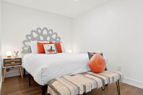 Calm bedroom w/ plush bedding, soft neutrals & warm accents for a restful night’s sleep.