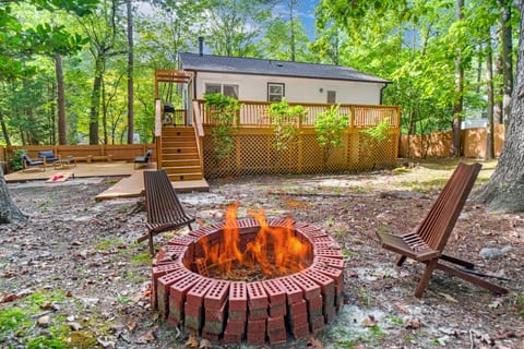Inviting backyard firepit surrounded by trees, perfect for evening chats and s’mores.