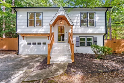 Charming front exterior w/ wooded surroundings and welcoming curb appeal.