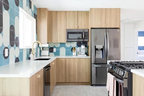 Experience the charm of our blue and timber kitchen, outfitted with all brand new appliances for your culinary adventures.