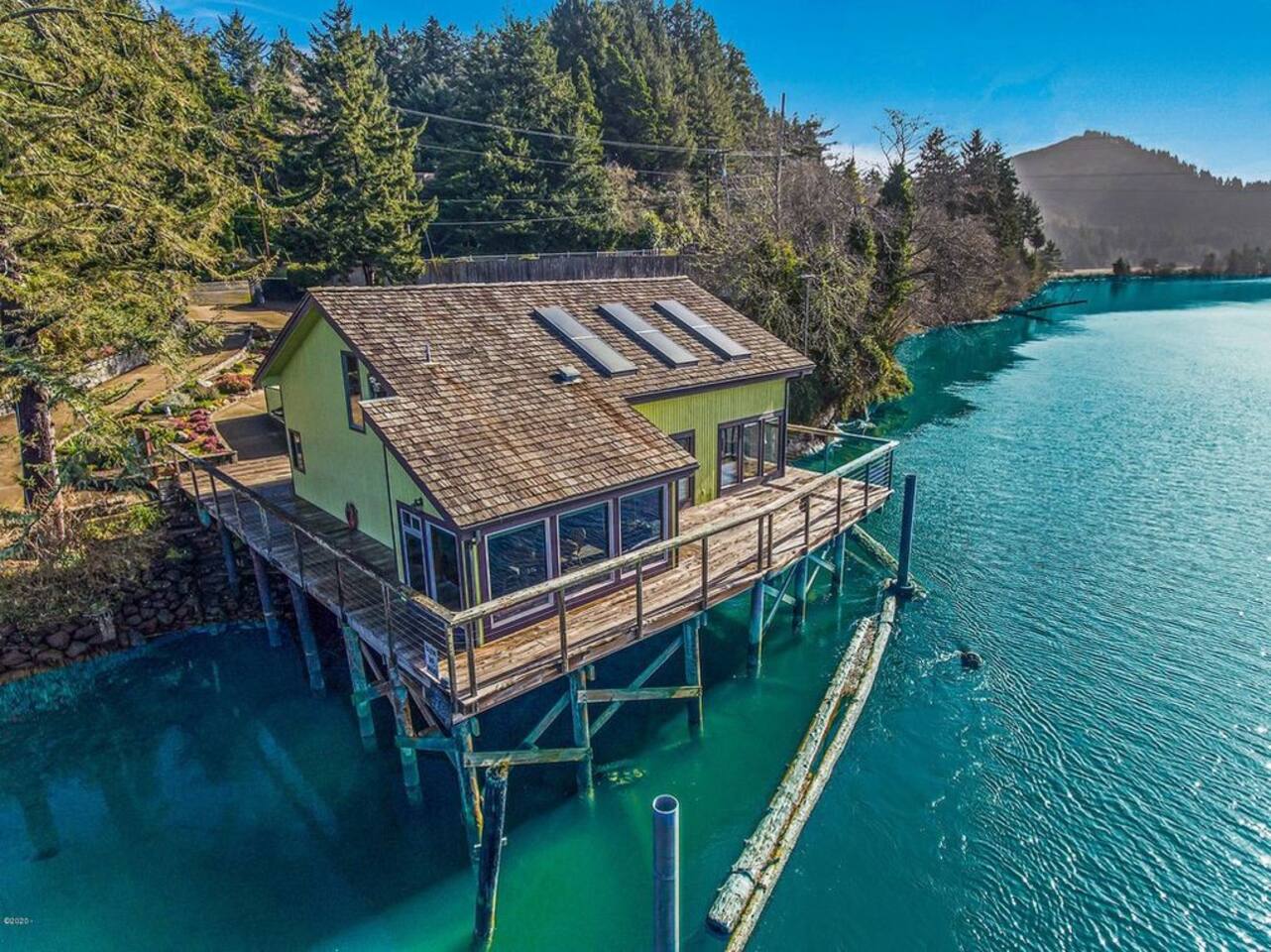 The house is surrounded by water on three sides amidst a wildlife sanctuary on the Siletz River