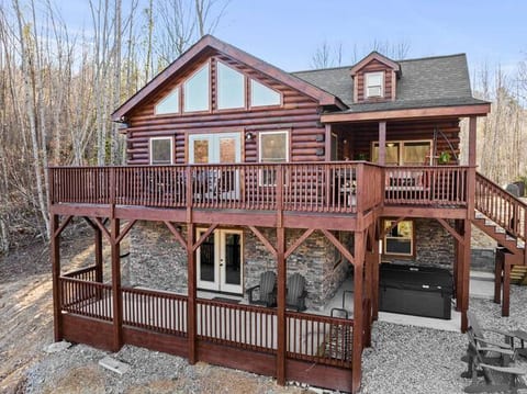 Large deck and porch with firepit and hot tub.