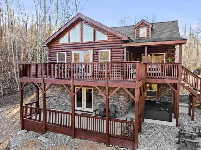 Large deck and porch with firepit and hot tub.