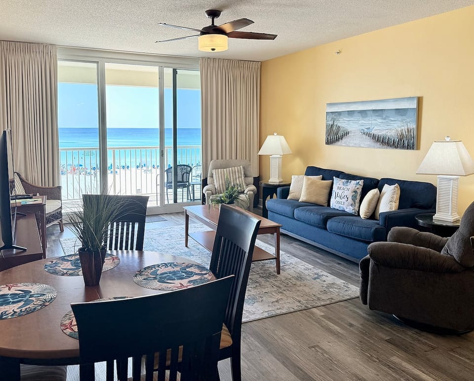 Spacious beachfront living area with balcony access