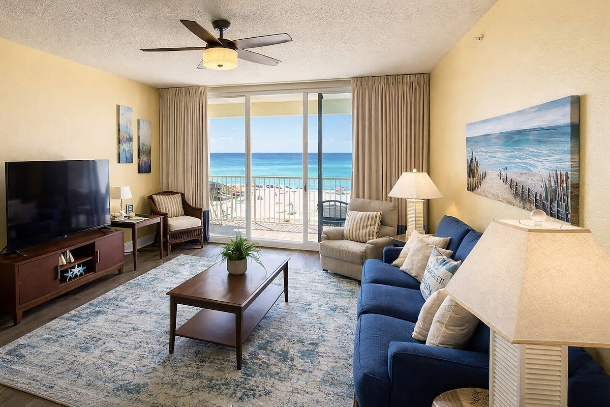Spacious beachfront living room that opens up to the amazing beachfront balcony! 2nd Floor Beachfront Condo w/Beach Chair Service!