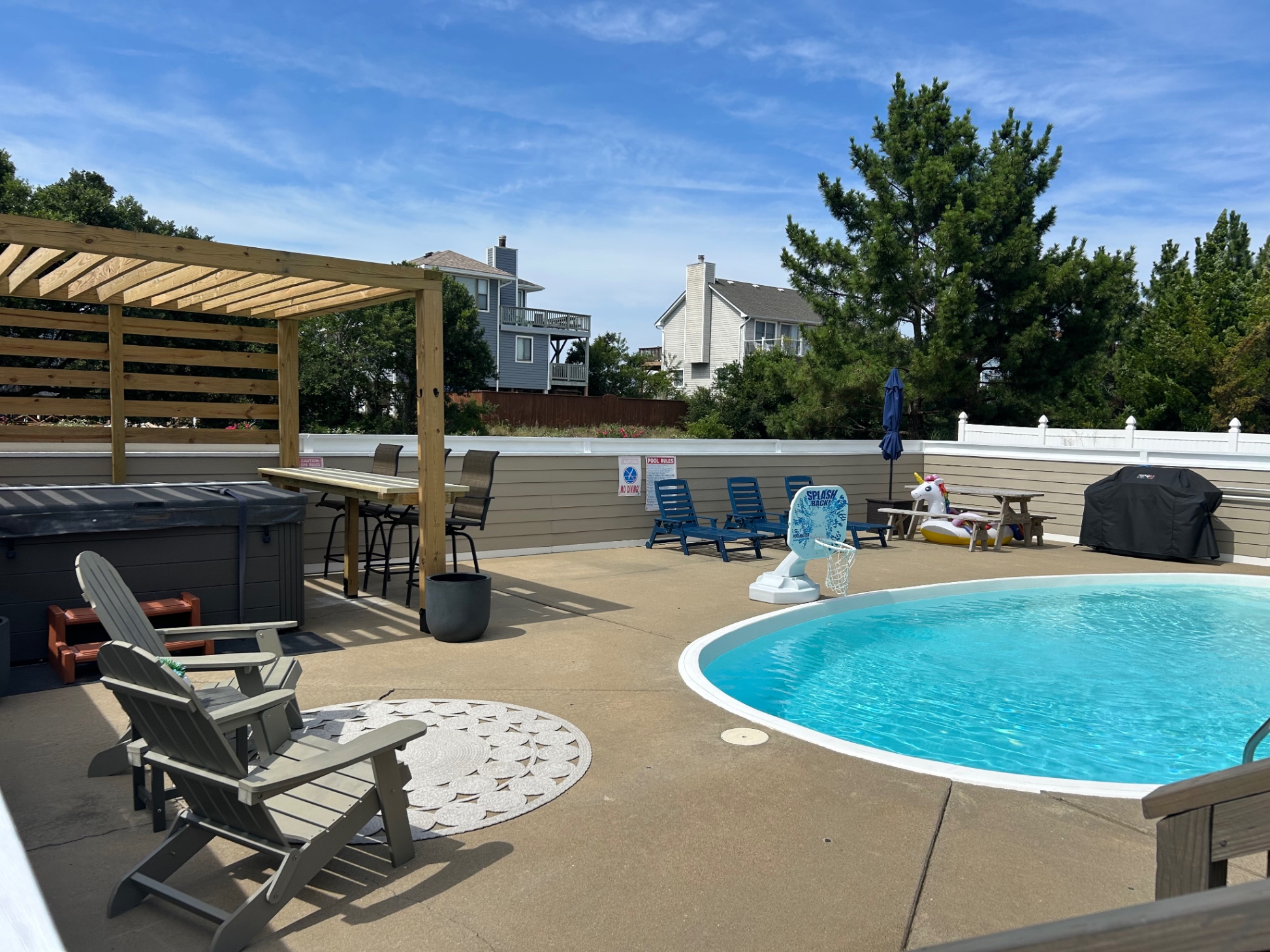 New pergola over the hot tub with bar-side table and chairs.