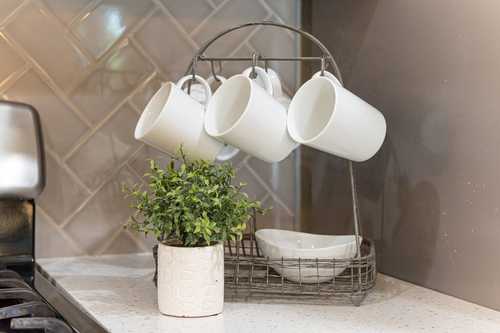 Start your day with a hot beverage using the convenient cups provided in this inviting kitchen