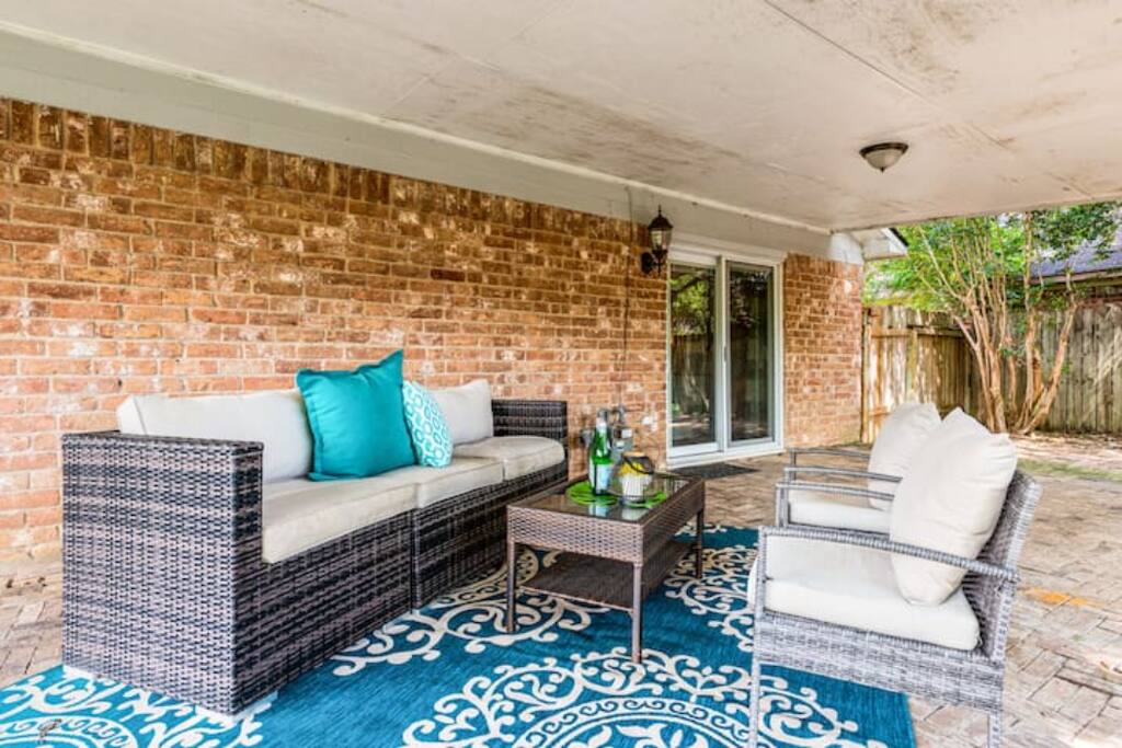 This patio is the perfect spot to entertain, with a sofa and chairs offering plenty of seating for guests