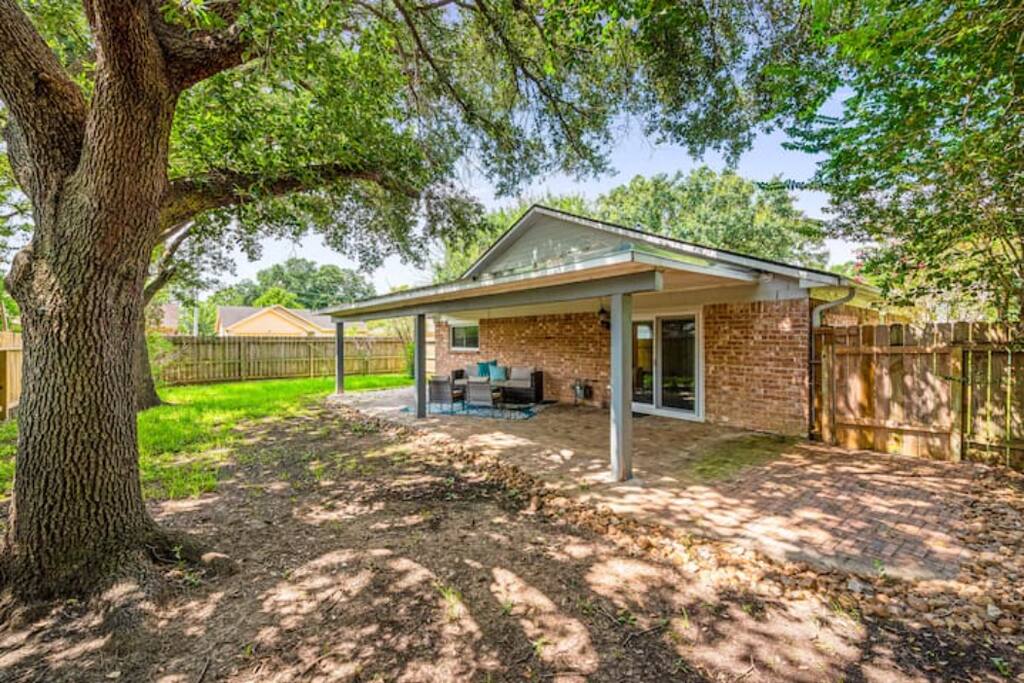 This backyard features a thoughtfully designed layout, with a lovely garden and cozy outdoor seating