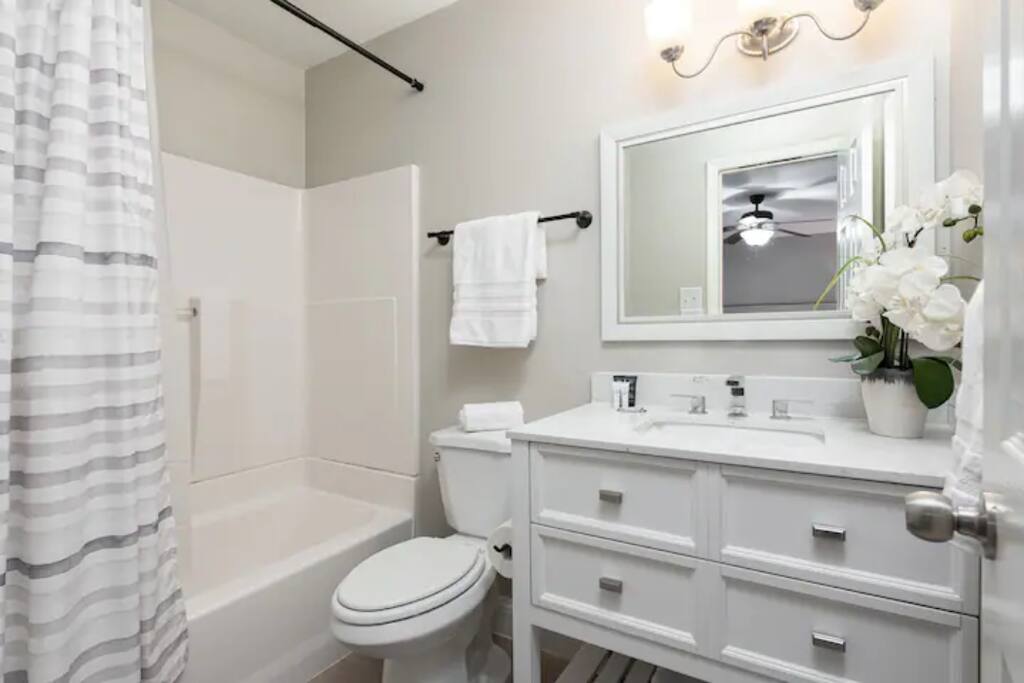 This chic bathroom is equipped with a bathtub, clean toilet and sink offering a perfect escape for relaxation and rejuvenation