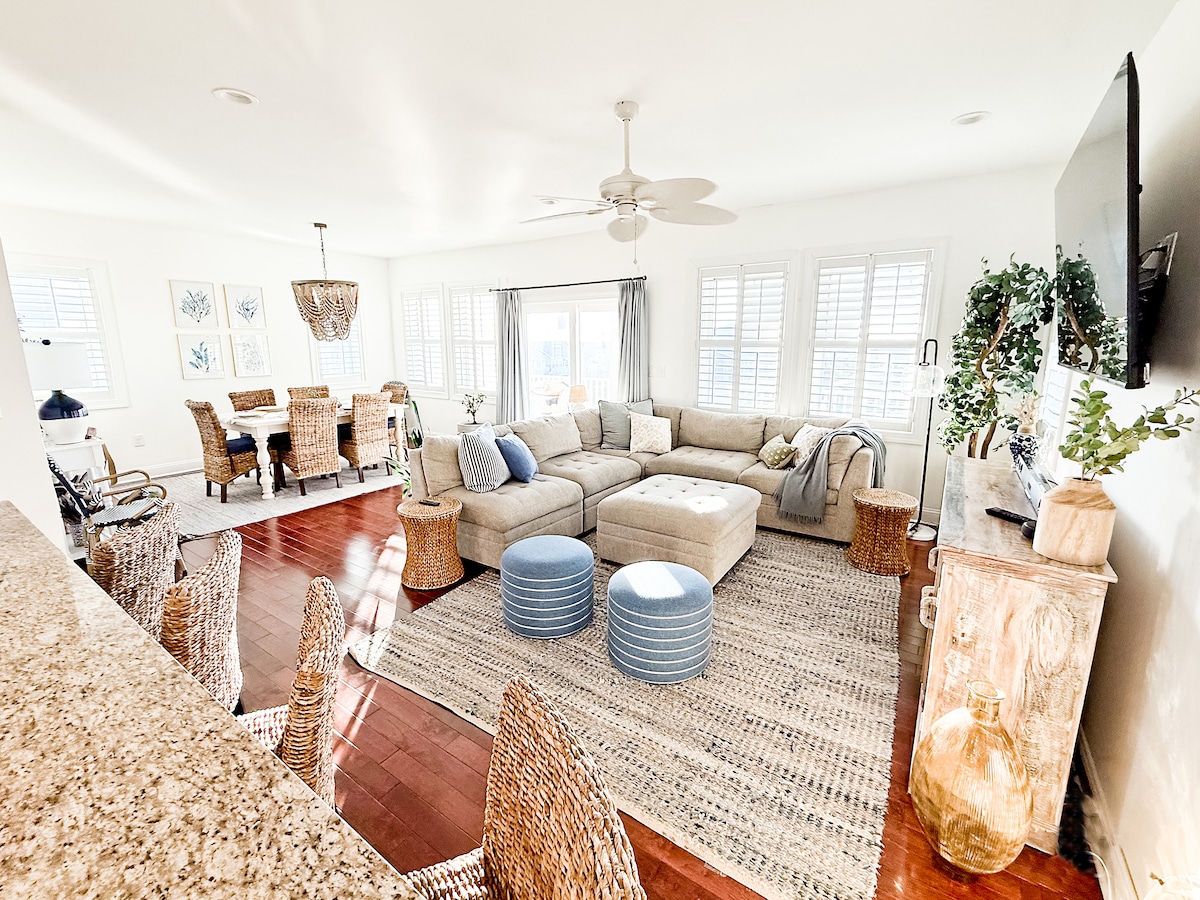 professional interior design, cozy sectional, 65" Roku TV, and dining area