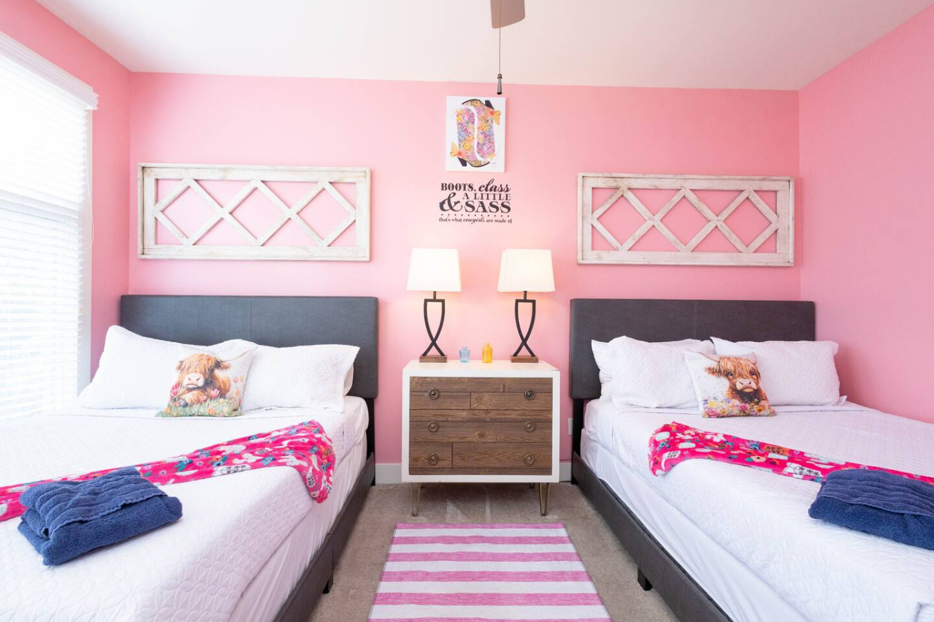 Sleepover vibes meet chic Nashville style! Two comfy queen beds with fun cowgirl accents and a “Boots, Class & Sass” theme make this the ultimate room for your besties.