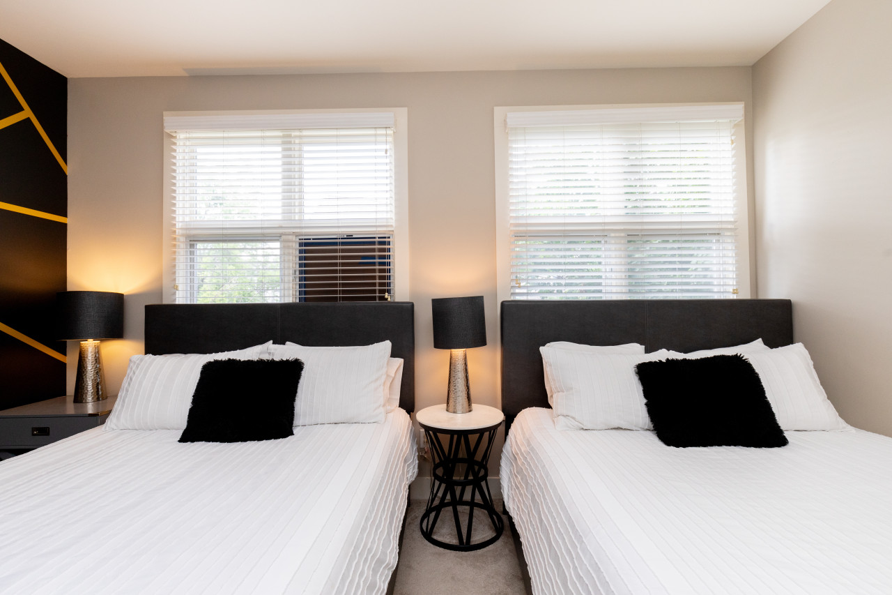 Second Bedroom with 2 Queen Beds and En-Suite Bathroom. Note: There is a cracked window in the first-floor bedroom that we have placed a temporary cover over to prevent potential injury until it can be repaired. This window is 35' off the ground and poses