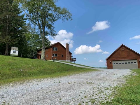 View of the house and garage as you turn into the driveway from the private road leading up to our home.